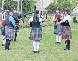  ??  ?? The Can-Am Pipes and Drums near the abbey.