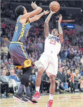  ?? AP ?? The Clippers’ Lou Williams, right, shoots against the Warriors’ Shaun Livingston.