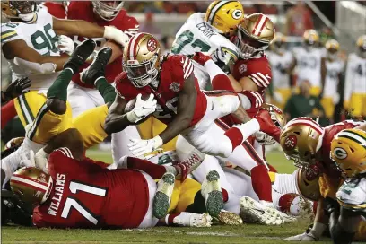  ?? JED JACOBSOHN — THE ASSOCIATED PRESS ?? San Francisco 49ers running back Trey Sermon, middle, runs for a touchdown against the Green Bay Packers during the second half Sunday in Santa Clara.