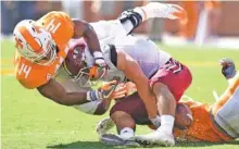  ?? STAFF PHOTO BY ROBIN RUDD ?? Tennessee linebacker Quart’e Sapp (14) and cornerback Justin Martin tackle UMass quarterbac­k Andy Isabella during their Sept. 23 game at Neyland Stadium.