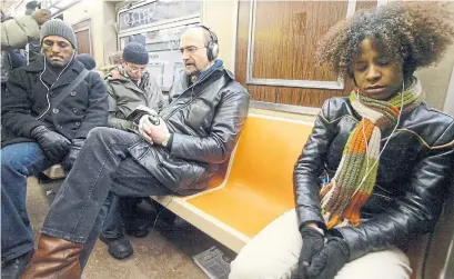  ?? MARY ALTAFFER ASSOCIATED PRESS FILE PHOTO ?? Headphones are a common sight on New York City’s subway as commuters take a break from the noise around them.