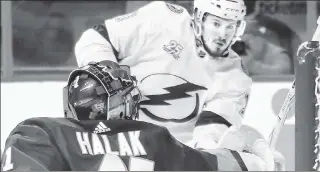  ?? Getty Images ?? RIGHT AT HOME: Ex-Ranger J.T. Miller, challengin­g Islanders goalie Jaroslav Halak, scored twice in the Lightning’s 7-6 win at Barclays Center on Thursday.