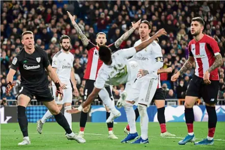  ?? — AFP ?? off balance: real madrid’s vinicius Junior takes a tumble during the la liga match against athletic bilbao at the bernabeu on sunday.