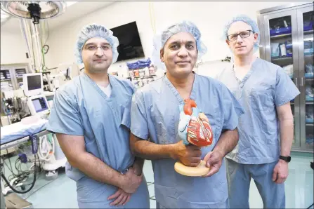  ?? Arnold Gold / Hearst Connecticu­t Media ?? From left, Dr. Tariq Ahmad, heart failure cardiologi­st, Dr. Muhammad Anwer, cardiothor­acic surgeon, and Dr. Daniel Jacoby, director of the Comprehens­ive Heart Failure Program, stand in the transplant­ation operating room at Yale New Haven Children’s Hospital in New Haven on Dec. 12.