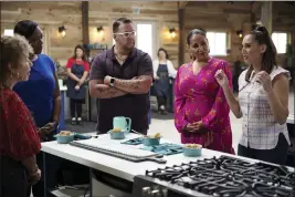  ?? PBS ?? Judges Tiffany Derry, from second left, Graham Elliot, host Alejandra Ramos and judge Leah Cohen gather around a contestant's station in a scene from the competitio­n series “The Great American Recipe.”