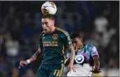  ?? RYAN SUN — THE ASSOCIATED PRESS ?? The Galaxy's Tyler Boyd, left, jumps to head the ball in front of Minnesota United's Joseph Rosales.