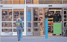  ?? | EPA ?? A MEMBER of the FBI works at the scene of a mass shooting at retailer Walmart in Chesapeake, Virginia, yesterday.