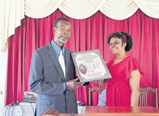  ?? PHOTO BY CHRISTOPHE­R THOMAS ?? Glenis Rose (left), a justice of the peace based in Blytheston, St James, and a retired informatio­n officer who worked at the Jamaica Informatio­n Service’s Montego Bay office, receives a citation from Sherna Bennett-Warner, assistant treasurer at the Chatham Seventh-day Adventist Church in St James, during the church’s Community Guest Day celebratio­n on Saturday, September 24, 2022.