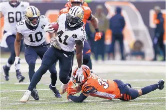  ?? GARY LANDERS/ASSOCIATED PRESS ?? New Orleans Saints running back Alvin Kamara (41) breaks away from Cincinnati Bengals free safety Jessie Bates in the first half of Sunday’s game in Cincinnati.