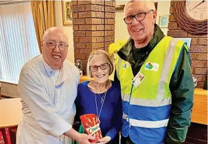  ?? ?? ● Chef Ken and Volunteer Driver Allan presented June with a box of Celebratio­ns to mark the milestone.
