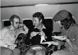  ?? Photograph: Courtesy of Sam Emerson ?? Tony King (centre) with Elton John and John Lennon, en route to Boston in 1974.