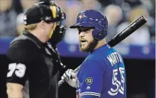  ?? FRANK GUNN THE CANADIAN PRESS ?? The Toronto Blue Jays’ Russell Martin has words with home plate umpire Tripp Gibson during a game last May. On Friday, the soon-to-be 36-year-old catcher was traded to the Los Angeles Dodgers, with the Blue Jays likely to eat a lot of Martin’s 2019 salary.