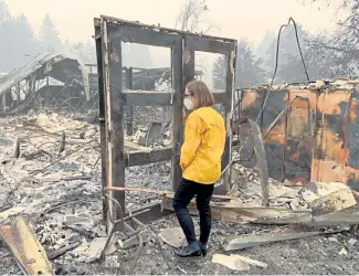  ?? The Associated Press ?? Gov. Kate Brown visits Beach Creek, Ore., on Wednesday. For policymake­rs, the state’s disastrous fires have illustrate­d the consequenc­es of delay and have prompted new conversati­ons about some of the lasting changes that until now have eluded lawmakers.