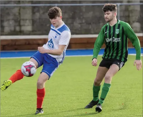  ?? Photo by Domnick Walsh ?? Harry Buckley, MEK Galaxy, gets his shot away as Derek Healy, Fenit Samphires, tries to close him down during their Premier A game at Mounthawk Park last Sunday.