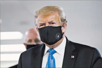  ?? PATRICK SEMANSKY/AP ?? President Donald Trump wears a mask Saturday at Walter Reed National Military Medical Center in Bethesda, Maryland.