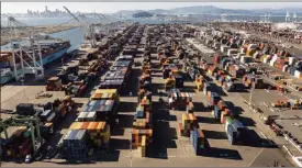  ?? AP photo ?? Containers line a Port of Oakland shipping terminal on Wednesday in Oakland, Calif. Intense demand for products has led to a backlog of container ships outside the nation's two largest ports along the Southern California coast.