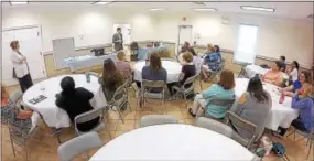  ?? CHRIS BARBER — DIGITAL FIRST MEDIA ?? Library employees from throughout the county join at Penn Township to learn about the opioid antagonist Narcan.