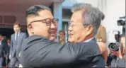  ?? AP ?? Kim Jong Un (left) and Moon Jaein embrace after the meeting.