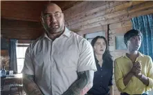  ?? (Universal Pictures via AP) ?? This image released by Universal Pictures shows Dave Bautista, from left, Abby Quinn, and Nikki Amuka-Bird in a scene from “Knock at the Cabin.”