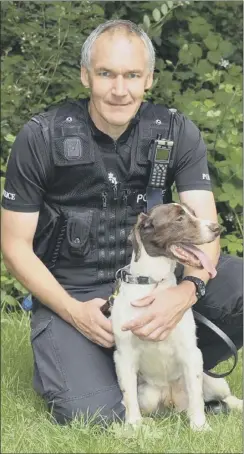  ??  ?? PC Andy Crouch with Jake, who died before getting his gong