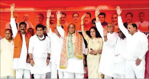  ??  ?? Federal Home Minister Rajnath Singh and BJP MP and the party’s Lok Sabha candidate from Mathura, Hema Malini, and other party leaders wave at supporters during an election rally in Mathura yesterday.