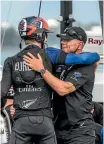  ??  ?? Team NZ helmsman Peter Burling, left, gets a hug from Grant Dalton.