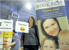  ?? RAY SPITERI/POSTMEDIA NEWS ?? Kaitlin Dunn, a committee member for the Nova House Book Riot, is one of many volunteers helping to set up for the 40th annual event, which starts with a pre-sale Wednesday and continues through Sunday at the Niagara Square on Montrose Road in Niagara...