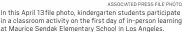  ?? ASSOCIATED PRESS FILE PHOTO ?? In this April 13file photo, kindergart­en students participat­e in a classroom activity on the first day of in-person learning at Maurice Sendak Elementary School in Los Angeles.