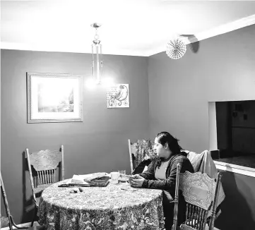  ??  ?? Sheila, 23, eats her breakfast at home before heading to a physical therapy appointmen­t in Gaithersbu­rg, Maryland.