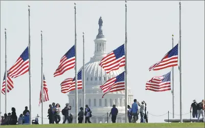  ?? MARK WILSON / AFP ?? US flags on the grounds of the Washington Monument are lowered to half-staff on Monday.