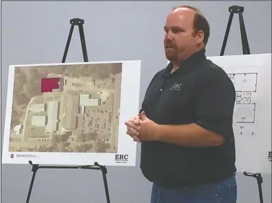  ?? Brittany Williams/News-Times ?? El Dorado Roofing & Constructi­on architect Michael Rogers is pictured showing Junction City School Board members and district administra­tors plans for a potential high school elective building.