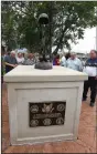  ?? NWA Democrat-Gazette/ FLIP PUTTHOFF ?? People gather Tuesday around the Springdale Fallen Soldier Memorial after a ceremony. The memorial honors soldiers from Springdale who have died in battle since World War I.