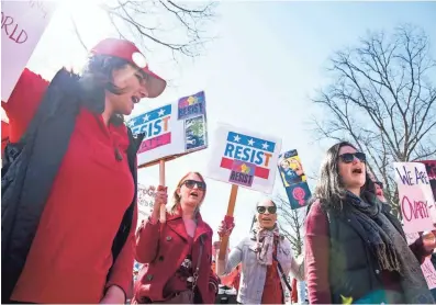  ?? JARRAD HENDERSON, USA TODAY ?? Lindsay Wooten, 33, Hope Hassell, 33, and Melissa Cooley, 31, march to mark Internatio­nal Women’s Day in Washington. Women in more than 50 countries held events calling for equal pay and protection of reproducti­ve rights.