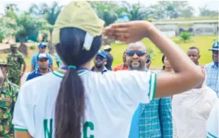  ??  ?? Minister of Youths and Sports Developmen­t, Sunday Dare being saluted by a corp member in Keffi