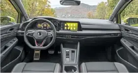  ?? ?? The cloth interior of the 2024 Volkswagen GTI is far more comfortabl­e than one expects from a hot hatch. A shifter lever follows the path laid by the Audi S3.