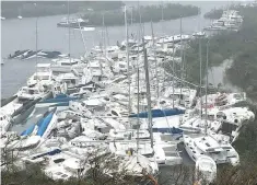  ??  ?? PLEASURE CRAFT lie crammed against the shore in Paraquita Bay as the eye of hurricane Irma passed Tortola, British Virgin Islands Sept. 6.