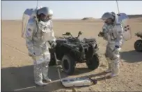  ?? SAM MCNEIL-THE ASSOCIATED PRESS ?? Two scientists test space suits and a geo-radar for use in a future Mars mission in the Dhofar desert of southern Oman.