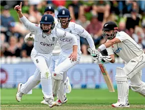  ?? PHOTOSPORT ?? Ollie Pope takes a sharp catch at silly point to leave Black Cap Daryl Mitchell looking like a stunned mullet at the Basin Reserve in Wellington yesterday.