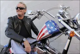  ?? CHRIS PIZZELLO - ASSOCIATED PRESS ?? In this Oct. 23, 2009, file photo, Peter Fonda, poses atop a Harley-Davidson motorcycle in Glendale, Calif.