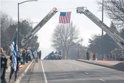  ?? AAron Ontiveroz, The Denver Post ?? Motorcycle­s lead the way in Friday’s funeral procession for Adams County sheriff ’s Deputy Heath Gumm. Gumm, who was shot to death Jan. 24 while chasing a suspect wanted in connection with a fight, was remembered with laughter and tears during a...