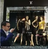  ??  ?? A man walks by a Louis Vuitton shop in Hong Kong.