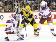  ?? Gene J. Puskar / Associated Press ?? Rangers goalie Alexandar Georgiev stopps Penguins forward Sidney Crosby as Marc Staal defends during the second period of New York’s 6-5 loss on Sunday.