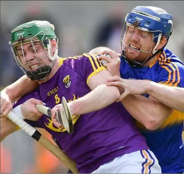  ??  ?? Tipperary midfielder Jason Forde holds on to the ball despite coming under strong pressure from Wexford duo