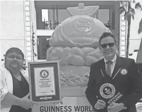  ?? COURTESY OF TROY LANDWEHR ?? Troy Landwehr, left, broke the Guinness world record for largest cheese sculpture in 2015. He’s standing aside Michael Empiric from Guinness World Records.