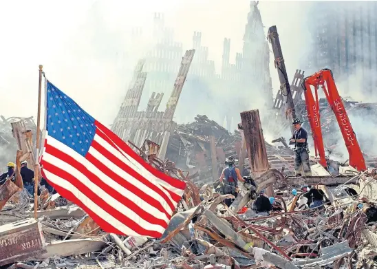  ??  ?? AMERICAN NIGHTMARE: Rescue workers search for survivors among the ruins of the World Trade Centre at Ground Zero in 2001.