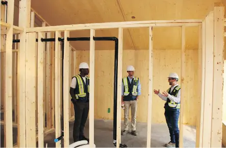  ?? BROOKFIELD RESIDENTIA­L ?? Doug Owens, senior director of Operations for Brookfield Residentia­l, right, speaks about passive house constructi­on techniques with Seyi Oyewumi senior business analyst, sustainabi­lity and marketing, left, and Brendan McCashin, senior manager,...