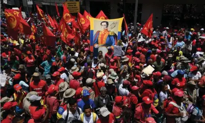 ??  ?? Supporters of Maduro display an image of the South American liberator Simon Bolivar during a May Day rally in Caracas on 1 May 2019. Photograph: Yuri Cortéz/AFP/Getty Images