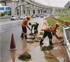  ??  ?? Pekerja penyelengg­araan jalan Glenmarie, Subang, kelmarin. membersihk­an lumpur di LRT
