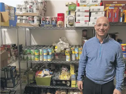  ?? NEIL STEINBERG/SUN-TIMES ?? Danny Weber, who grew up in Rogers Park, is a volunteer driver delivering food for The Ark. “The best thing about delivering is everyone is happy,” he said, standing in the group’s Northbrook food pantry. “They’re just so grateful.”