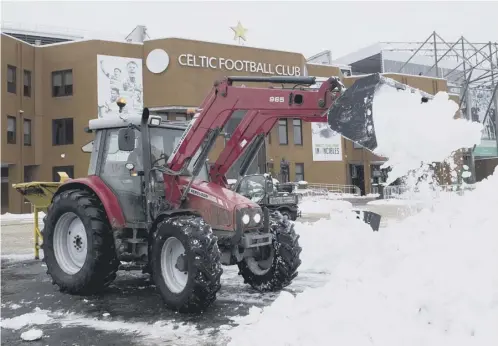  ??  ?? Diggers have been used at Celtic Park this week to clear the snow outside the stadium ahead of today’s Scottish Cup tie with Morton.
